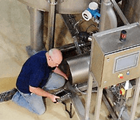 Image of man inspecting a machine