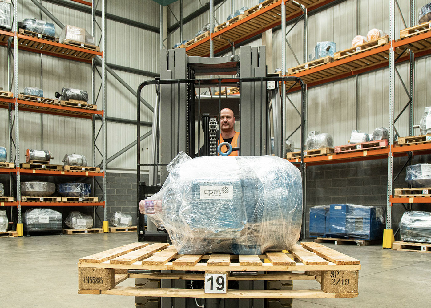 An Image of a CPM Engineering Motor Being Carried Through a Warehouse on a Pallet