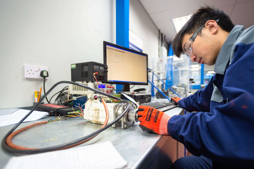 Photo of a CPM Engineer Analysing and Repairing a Motor